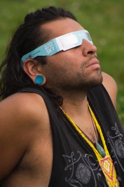 Man with eclipse glasses looking up
